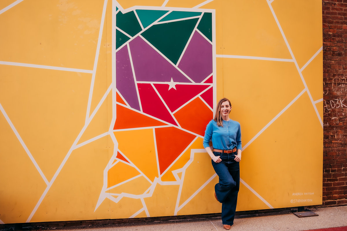 Devon Wellington in front of an Indiana mural