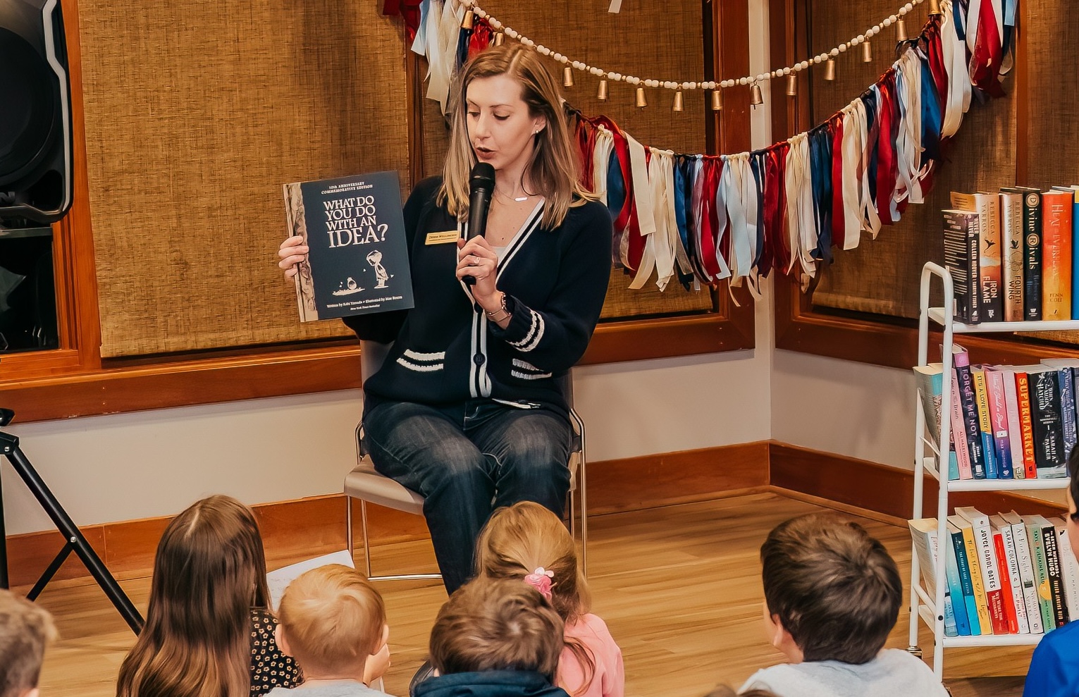 Devon Wellington speaking with children at a community event